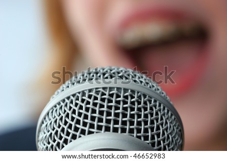 The voice of a singer is recorded at the gig with a microphone.