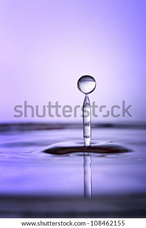 Beautiful tranquil purple water drop and splash