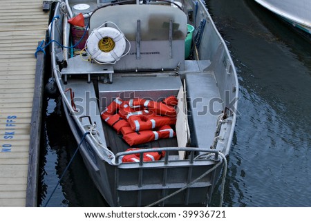 Metal boat with orange life vests or life preservers