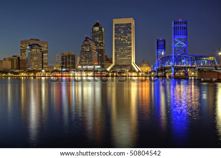 Beautiful sunset on St. John\'s River and Jacksonville, Florida skyline showing the John T. Alsop Jr. Bridge