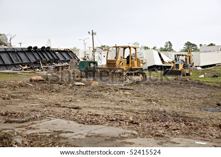 Brick High School one week after tornado damage - earthmoving equipment is shown on the grounds, along with destroyed mobile temporary classrooms.