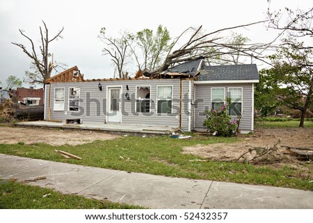 Residence a week after being struck by a tornado.  Some clean up has been completed.