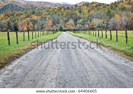 Beautiful curved unpaved country road lined with Autumn trees in Great Smoky Mountains National Park