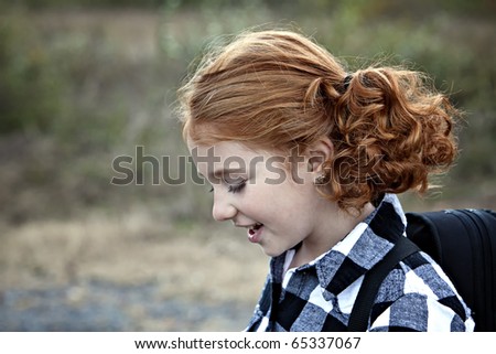 Profile of Beautiful young girl with red hair outdoors in Autumn season