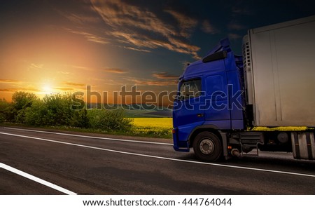road on sunset. blue truck on the asphalt rural road