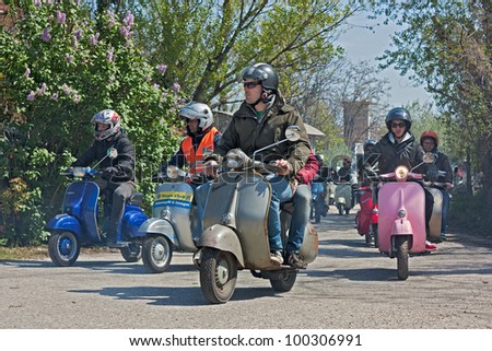 SANTARCANGELO DI ROMAGNA (RN) ITALY -  APRIL 9: a group of bikers riding a vintage italian  scooters Lambretta and Vespa at motorcycle rally on April 9,2012 in Santarcangelo di R (RN) Italy - April 9