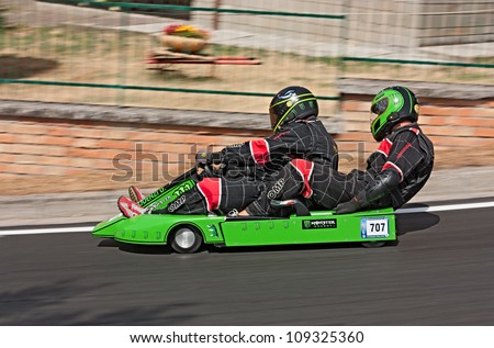 PREDAPIO ALTA, ITALY - JULY 28: Unidentified drivers on a wooden soap box car race at european championship speed down on July 28, 2012 in Predappio Alta, FC, Italy.