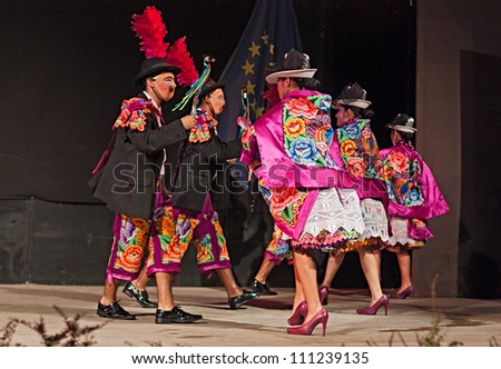 RUSSI, ITALY- AUGUST 5:  The ensemble Imagenes del Peru' - peruvian dancers with colorful dress and mask performs popular dance at International folk festival on August 5, 2012 in Russi, Ravenna, Italy