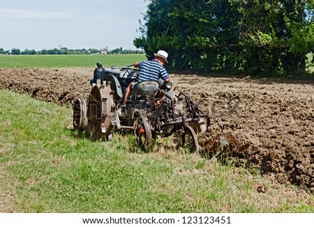 BASTIA, RAVENNA, ITALY - MAY 29: unidentified farmer plow the land with an old tractor during the recall of the old farm work \