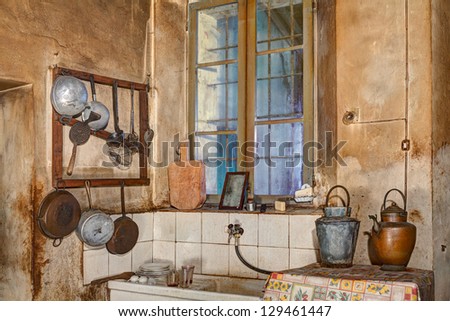 corner of an old kitchen with sink, cooking tools and ancient jugs water - retro kitchen equipment, pitchers and utensils of old times