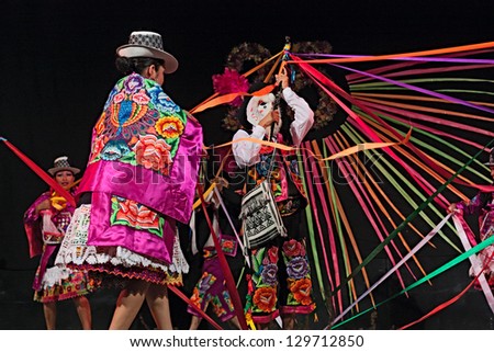RUSSI, ITALY - AUGUST 5: ensemble Imagenes del Peru\' - peruvian dancers with colorful dress and mask performs popular dance at International folk festival on August 5, 2012 in Russi, Ravenna, Italy