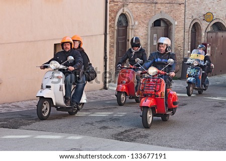 VERUCCHIO (RN) ITALY - APRIL 9: a group of bikers riding a vintage italian  scooters Vespa at motorcycle rally of Vespa Club Santarcangelo di Romagna on April 9, 2012 in Verucchio (RN) Italy