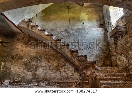 dark basement with stairs and window of an old abandoned country house