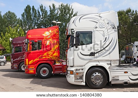 RIOLO TERME, RA, ITALY - JUNE 1: shiny and painted tractor trailer trucks parked during the truck rally \