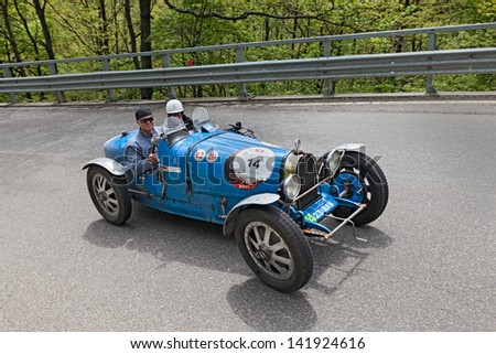 PASSO DELLA FUTA (FI), ITALY - MAY 18: unidentified drivers on an old racing car Bugatti T 35 T (1926) runs in the historical race Mille Miglia 2013, on May 18, 2013 in Passo della Futa (FI) Italy