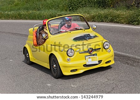 BORGO RIVOLA (RA), ITALY - MAY 1: unidentified crew on a yellow tuned car Fiat 500 Abarth roadster in rally for vintage cars \