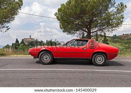 FOGNANO (RA), ITALY - JULY 7: unidentified crew on a vintage car Alfa Romeo Montreal runs on the italian hills during the rally \