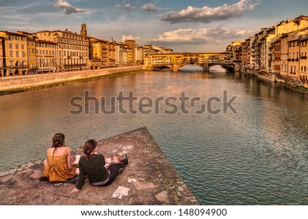 Florence, Italy - April 17: Tourism In City Of Art, Unidentified Two Young Girls Draws A Sketch Of Ponte Vecchio, The Famous Old Bridge Over The Arno River, On April 17, 2013 In Florence, Italy