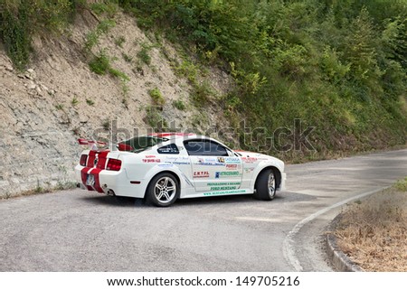 DOVADOLA, ITALY - JULY 28: the crew Ravaglioli - Baldini on a racing car Ford Mustang in hairpin bend at Rally della Romagna 2013, on July 28, 2013 in Dovadola, FC, Italy