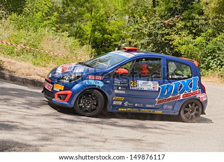 DOVADOLA, ITALY - JULY 28: the crew Battilani - Cerlini on a racing car Renault Twingo in hairpin bend at Rally della Romagna 2013, on July 28, 2013 in Dovadola, FC, Italy
