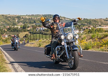 RIOLO TERME, ITALY - SEPTEMBER 22: unidentified happy driver leads a group of bikers riding Harley Davidson at motorcycle rally \