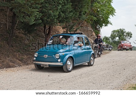 FOGNANO, RA, ITALY - JULY 7: unidentified crew on a vintage car Fiat 500 runs on a dirt road in the italian hills during the rally \