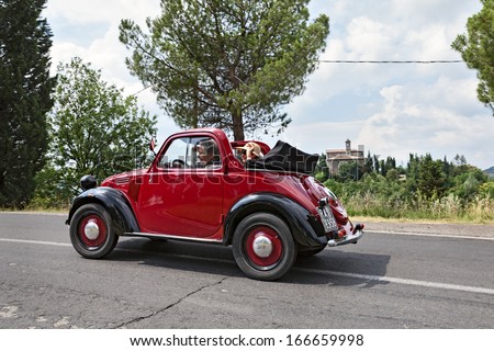 FOGNANO, RA, ITALY - JULY 7: unidentified crew on an old italian car Fiat 500 Topolino runs on the italian hills during the rally 