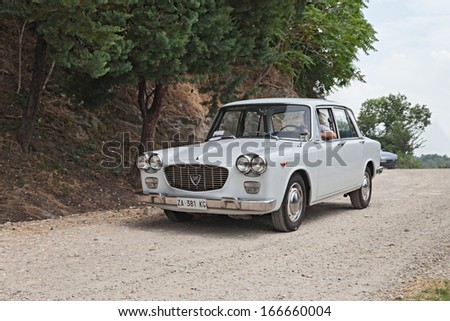 FOGNANO, RA, ITALY - JULY 7: unidentified crew on a vintage car Lancia Flavia runs on a dirt road in the italian hills at the rally \