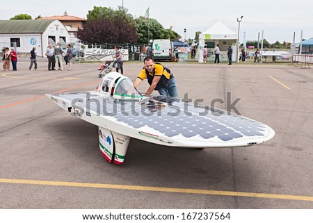 LUGO. RA. ITALY  SEPTEMBER 19: unidentified mechanic moves the solar powered vehicle Emilia 2 at  Expo\' AEM-ZERO Alternative Energy for Mobility Zero Emissionon September 19, 2013 in Lugo. RA. Italy