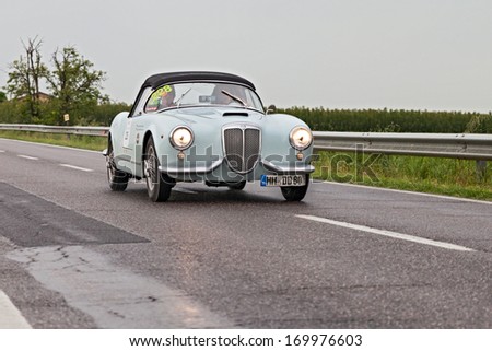 RAVENNA, ITALY - MAY 17: unidentified drivers on a vintage sports car Lancia Aurelia B24 spider (1955) in rally Mille Miglia 2013, the italian historical race on May 17, 2013 in Ravenna, Italy