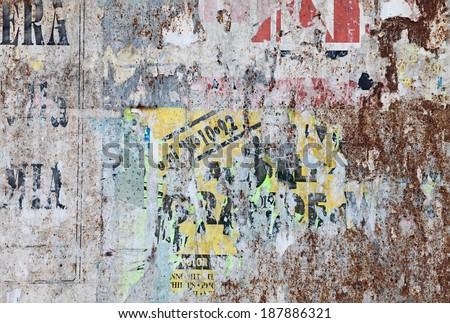 grunge ripped poster background - texture of torn advertisement on an old rusty billboard panel
