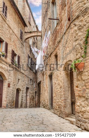 a picturesque typical corner with clothes hanging in the old town of Volterra, Tuscany, Italy
