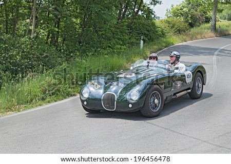 COLLE DI VAL D\'ELSA, SI, ITALY - MAY 17: unidentified crew on a vintage competition car Jaguar runs in historical rally Mille Miglia, on May 17, 2014 in Colle di Val d\'Elsa, Tuscany, Italy
