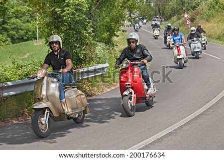 MELDOLA (FC) ITALY - JUNE 14: a group of bikers riding a vintage italian scooters at rally \