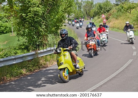 MELDOLA (FC) ITALY - JUNE 14: a group of bikers riding a vintage italian scooters at rally \