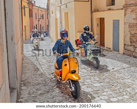 BERTINORO (FC) ITALY - JUNE 14: a group of bikers riding a vintage italian scooters at rally \