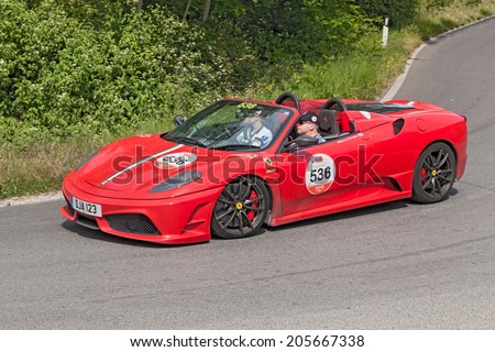 COLLE DI VAL D\'ELSA, SI, ITALY - MAY 17: the crew Armstrong - Christie on a Ferrari F430 Scuderia 16M in Ferrari tribute to Mille Miglia, on May 17, 2014 in Colle di Val d\'Elsa, Tuscany, Italy