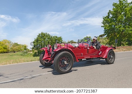 COLLE DI VAL D\'ELSA, SI, ITALY - MAY 17: the crew Elicabe - Gessler on a racing car Alfa Romeo 6C 1500 GS Zagato (1933) in rally Mille Miglia, on May 17, 2014 in Colle Val d\'Elsa, SI, Tuscany, Italy