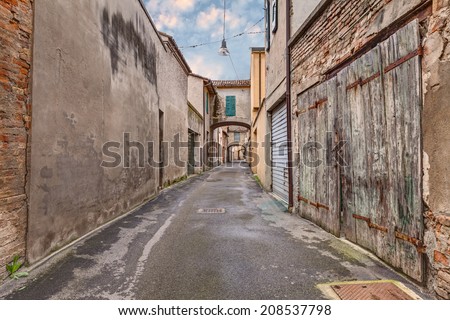 narrow dark alley in the old town - grunge aged street  - distressed alleyway in the italian city