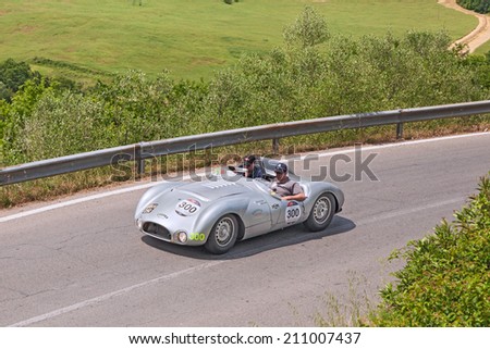 COLLE DI VAL D\'ELSA, SI, ITALY - MAY 17: the crew Hood -  Riedling on a vintage racing car Cooper T33 Jaguar (1954) in historical race Mille Miglia, on May 17, 2014 in Colle di Val d\'Elsa, SI, Italy