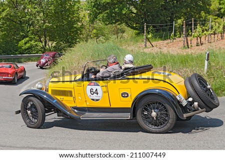 COLLE DI VAL D'ELSA, SI, ITALY - MAY 17: the crew Frascari - Teneggi on ancient sports car Bugatti T 40 (1930) runs in historical race Mille Miglia, on May 17, 2014 in Colle di Val d'Elsa, SI, Italy