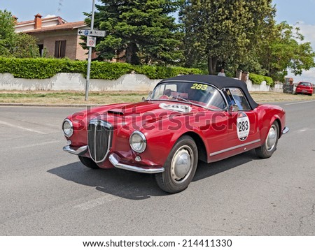 COLLE DI VAL D\'ELSA, SI, ITALY - MAY 17: the crew Terlizzi Catasso on a vintage car Lancia Aurelia B24 Spider (1955) in rally Mille Miglia, on May 17, 2014 in Colle di Val d\'Elsa, Tuscany, Italy