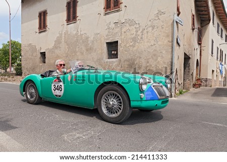 COLLE DI VAL D\'ELSA, SI, ITALY - MAY 17: the crew Dixon Harding on a vintage british car MG A Roadster (1955) in historical race Mille Miglia, on May 17, 2014 in Colle di Val d\'Elsa, Tuscany, Italy