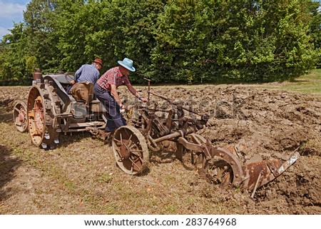 BASTIA,RA, ITALY - MAY 17: farmers recalling the old farm work plowing the field with an old tractor Landini during the country fair 