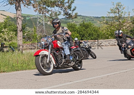 PREDAPPIO, ITALY - MAY 10: biker riding Harley Davidson motorbike with a group of bikers in motorcycle rally \