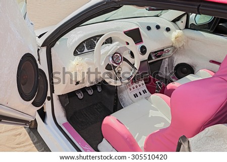 CESENATICO, ITALY - JULY 12: White and pink interior and dashboard of a tuning car exhibited at tuning car rally \