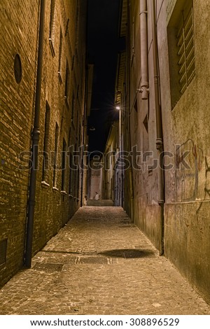 narrow dark alley in the old town - distressed alleyway in the italian city - grunge aged street at night