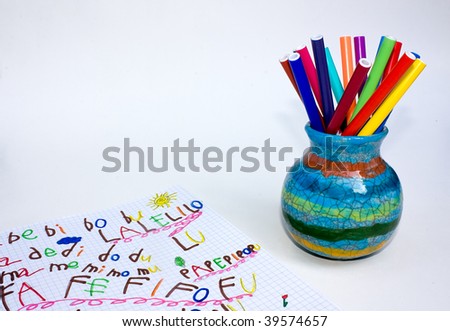 exercise book and ceramic pot with set of colored felt-pen - empty space for text