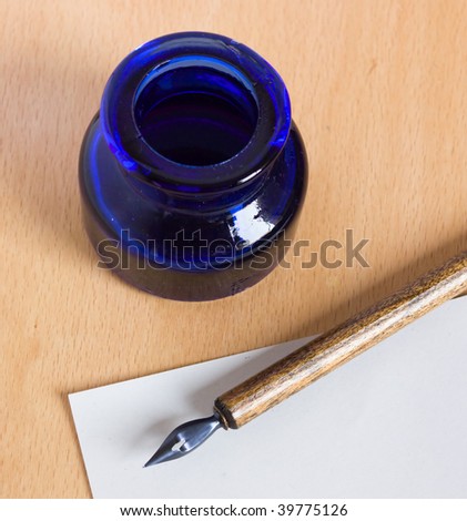 stock-photo-ink-pot-and-old-pen-for-handwriting-with-ink-and-nib-blank-paper-sheet-empty-space-39775126.jpg