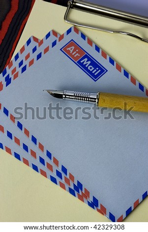 clipboard with letter paper, airmail envelopes and fountain pen, correspondence with foreign